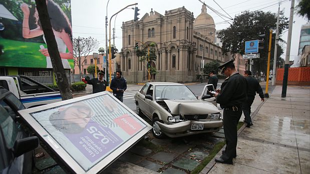 Inexplicablemente, los dos pasajeros del auto que chocó contra el afiche se fueron del lugar (Foto: Lino Chipana / El Comercio)
