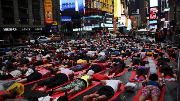 People practice yoga in Times Square as part of a Summer Solstice and International Day of Yoga celebration in New York June 21, 2015. REUTERS/Eduardo Munoz