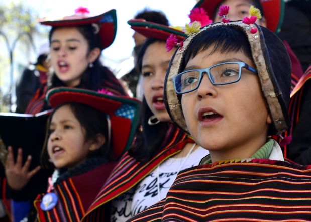 Children dressed in traditional clothing from Carabuco sing as they wait for the arrival of Pope Francis in Plaza Murillo in La Paz, Bolivia, Wednesday, July 8, 2015. Due to the altitude, the pontiff will spend only a few hours in the capital city La Paz, which is near El Alto, during his South American tour. Bolivia is the second of three countries the pontiff will be visiting during his South American tour. (AP Photo/Freddy Barragan)