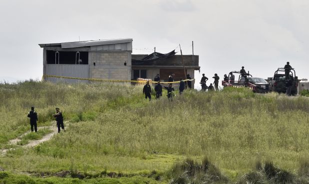 federal police check a house at the end of the tunnel through which Mexican drug lord Joaquin 