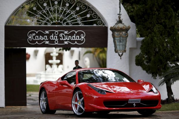 A federal policeman drives a seized luxury car from the residence of Brazilian Senator Fernando Collor de Mello, in Brasilia, Brazil July, 14, 2015. Brazilian police carried out their first search and seizure operations on Tuesday aimed at sitting lawmakers suspected of taking bribes in a corruption scandal at state-run oil firm Petrobras. Police seized luxury cars including a red Ferrari, a black Porsche and a gray Lamborghini from the home of Senator Collor a former president. REUTERS/Ueslei Marcelino