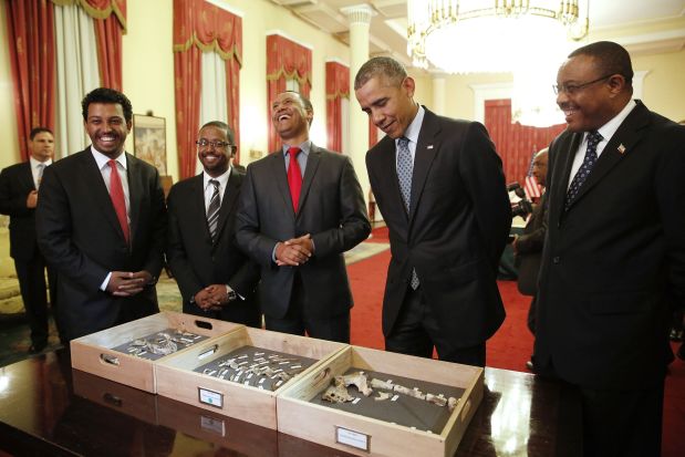 Dr. Zeresenay Alemseged Lemseged (C), of the California Academy of Sciences, laughs at a quip by U.S. President Barack Obama (2ndR) as he and Ethiopia's Prime Minister Hailemariam Desalegn (R) look at the bones of Lucy, an early human, before a State Dinner in Obama's honor at the National Palace in Addis Ababa, Ethiopia July 27, 2015. Lucy is the most famous fossil of the species Australopithecus afarensis, and was found in Ethiopia in 1974. REUTERS/Jonathan Ernst