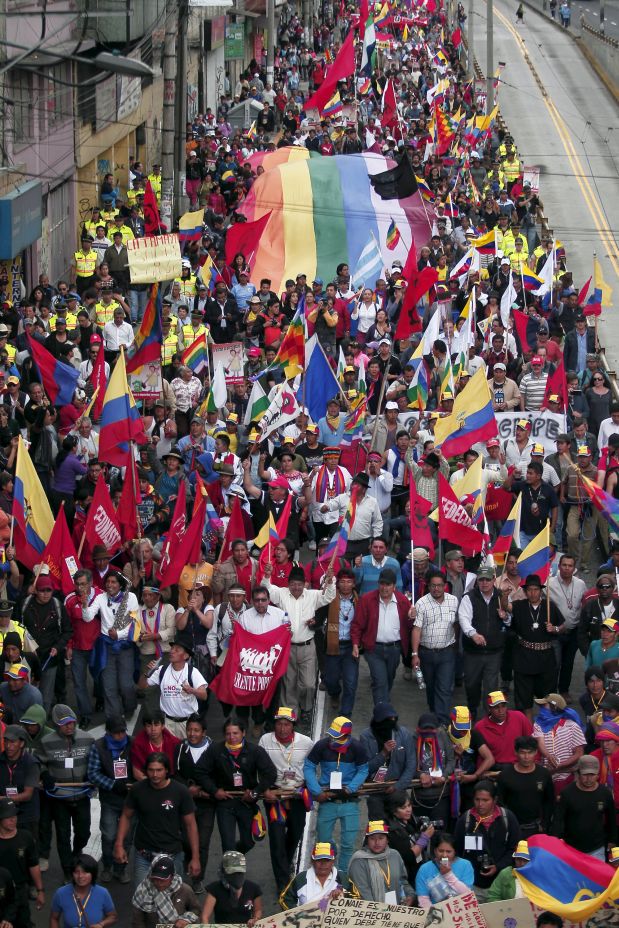 Protesters carry flags and banners while marching in Quito, Ecuador, August 12, 2015. Ecuadorean Indigenous from the Confederation of Indigenous Nationalities of Ecuador (CONAIE) are arriving in Quito to participate in a nation-wide strike on August 13 against the government of Ecuador's President Rafael Correa, according to local media. REUTERS/Guillermo Granja