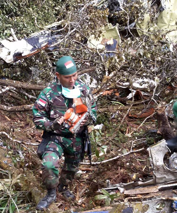 An Indonesian soldier carries the flight recorder from the Trigana Air Service ATR 42-300 crash site near Oksob village, Bintang Mountains district, Papua province, Indonesia, August 18, 2015 in this military handout photo provided by Antara Foto. All 54 people on board the Trigana Air aircraft were killed in the crash two days ago in Indonesia's Papua province, the latest in a string of aviation disasters in the Southeast Asian archipelago, officials said on Tuesday.     REUTERS/Pendam Cenderawasih/Antara Foto ATTENTION EDITORS - THIS IMAGE HAS BEEN SUPPLIED BY A THIRD PARTY. FOR EDITORIAL USE ONLY. NOT FOR SALE FOR MARKETING OR ADVERTISING CAMPAIGNS. MANDATORY CREDIT. INDONESIA OUT. NO COMMERCIAL OR EDITORIAL SALES IN INDONESIA. THIS PICTURE IS DISTRIBUTED EXACTLY AS RECEIVED BY REUTERS, AS A SERVICE TO CLIENTS.