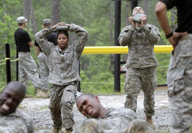 In this photo taken on April 19, 2015, one of the 20 female soldiers, top left, who is among the 400 students who qualified to begin Ranger School, does lunges in between obstacles on the Darby Queen, one of the toughest obstacle courses in U.S. Army training, at Fort Benning, Ga. Two women have passed the Army?s grueling Ranger test, but tougher and more dangerous jobs could lie ahead, senior officials told The Associated Press. The military services are poised to allow women to serve in most front-line combat jobs, including as special operations forces.  (Robin Trimarchi/Ledger-Enquirer via AP) MANDATORY CREDIT