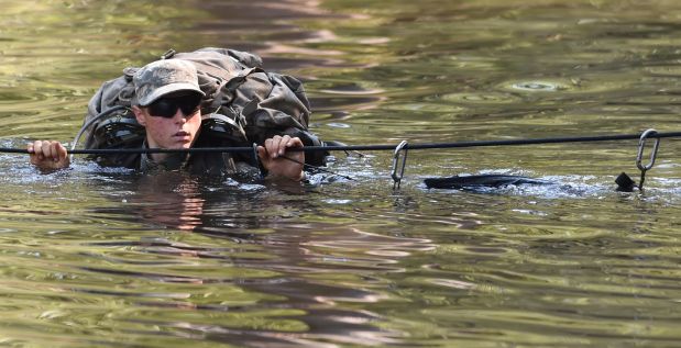 In this photo taken on Aug. 4, 2015, a female Army Ranger crosses the Yellow River on a rope bridge during Ranger School at Camp Rudder on Eglin Air Force Base, in Fla.  According to the Northwest Florida Daily News, she and one other female were the first to complete Ranger training and earn their Ranger tab this week. (Nick Tomecek/Northwest Florida Daily News via AP) MANDATORY CREDIT