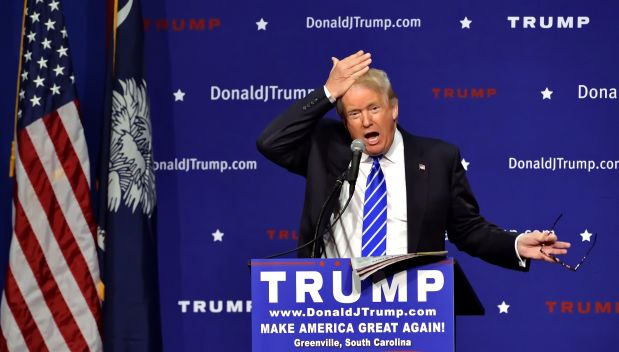 Republican presidential candidate Donald Trump pulls his hair back to show that it is not a toupee while speaking during a rally at the TD Convention Center, Thursday, Aug.  27, 2015, in Greenville, S.C. Trump says his trademark hairdo is for real. He told 1,800 people in South Carolina Thursday: 