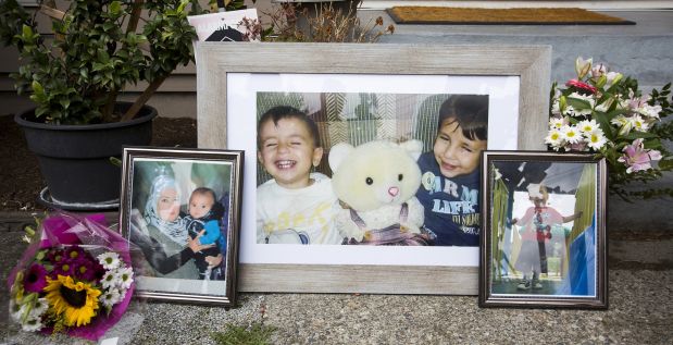 Photographs of Aylan Kurdi and Galip Kurdi, who were among 12 people who drowned in Turkey trying to reach Greece, are pictured outside of Tima Kurdi's home in Coquitlam, British Columbia September 3, 2015. A photograph of the tiny body of 3-year old Aylan Kurdi washed up in the Aegean resort of Bodrum swept social media on Wednesday and featured on front pages on Thursday, spawning sympathy and outrage at the perceived inaction of developed nations in helping refugees. REUTERS/Ben Nelms