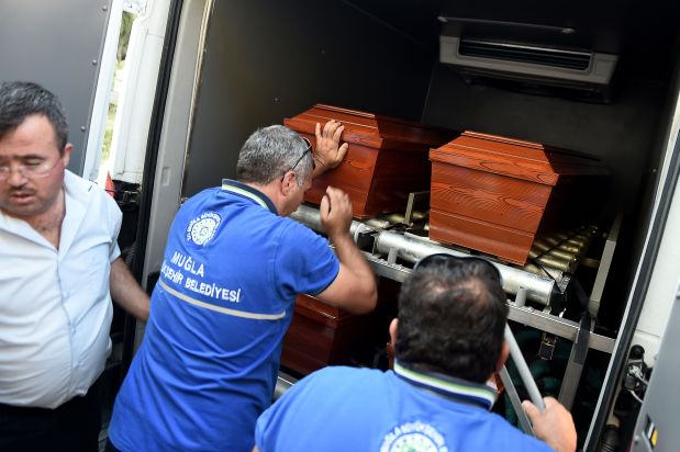 Men load onto a funeral vehicle the coffins of migrants and three-year old Aylan Kurdi, a Syrian boy whose body was washed up on a Turkish beach after a boat carrying refugees sank as it crossed to the Greek island of Kos, at the morgue in Mugla, southern Turkey, on September 3, 2015. The father of a three-year-old Syrian boy whose body was  washed up on a Turkish beach, an image that shocked the world, said on September 3 his children 