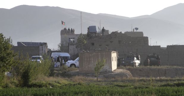 Afghan security members stand guard on the roof of the main prison building after an attack in Ghazni province, eastern Afghanistan, Monday, Sept. 14, 2015. An Afghan official says that more than 350 inmates have escaped after an attack by the Taliban insurgents on the main prison. (AP Photo/Rahmatullah Nikzad)
