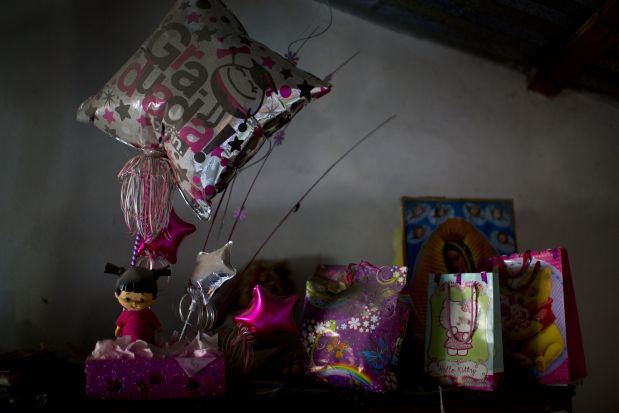 In this June 1, 2015, 2015 photo, high school graduation gifts for Berenice Navarijo Segura gather dust, awaiting her return atop a cabinet in her mother's home in Cocula, Mexico. On Berenice's graduation day, July 1, 2013, seventeen people, including Berenice, disappeared from Cocula, more than a year before 43 students from a teachers college were detained by police in nearby Iguala and never seen again. (AP Photo/Dario Lopez-Mills)