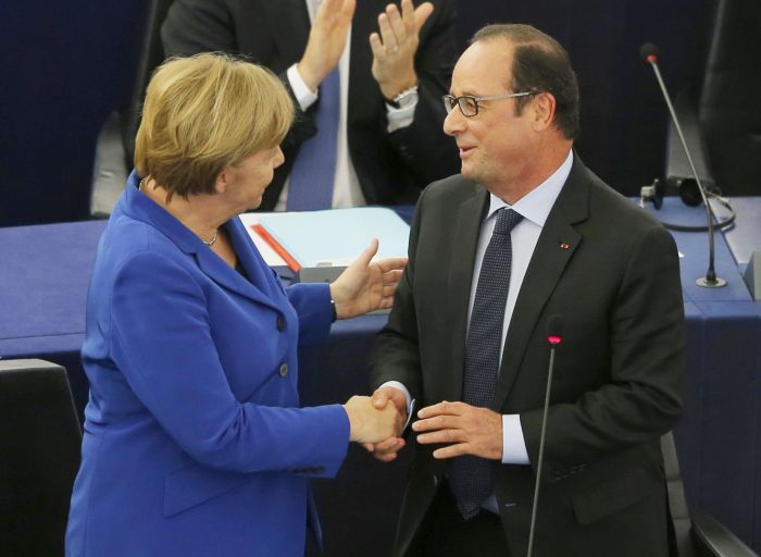 German Chancellor Angela Merkel (L) shakes hands with French President Francois Hollande (R) after addressing the European Parliament in Strasbourg, France, October 7, 2015. Angela Merkel and Francois Hollande address the European Parliament on Wednesday, hoping to bolster EU cohesion to face interlocking crises in an echo of Franco-German unity in the days after the fall of the Berlin Wall. REUTERS/Vincent Kessler