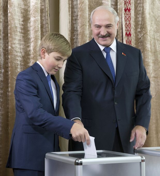 Belarus' President Alexander Lukashenko, accompanied with his son Nikolay, casts his ballot during a presidential election at a polling station in Minsk, Belarus, October 11, 2015. Belarussians head to the polls on Sunday to cast their vote in presidential elections all but certain to re-elect authoritarian incumbent Lukashenko for a fifth term. REUTERS/Vasily Fedosenko