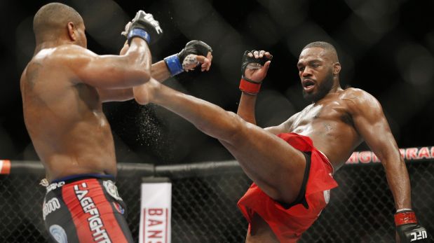 FILE - This Jan. 3, 2015 file photo Jon Jones, right, kicks Daniel Cormier during their light heavyweight title mixed martial arts bout at UFC 182, in Las Vegas. Jones pleaded guilty Tuesday, Sept. 29, to a charge stemming from a hit-and-run crash in Albuquerque that injured a pregnant woman, saying he took full responsibility for what the judge called a ?stupid decision? in the moments following the accident. (AP Photo/John Locher, File)