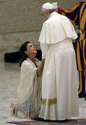 Pope Francis is greeted by Spanish Singer Maria Jose Santiago Medina during an audience with Roma, Sinti and others itinerant group members at the Vatican, Monday, Oct. 26, 2015. (AP Photo/Gregorio Borgia)
