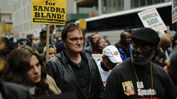 US film director Quentin Tarantino (C) takes part in a march against police brutality called 
