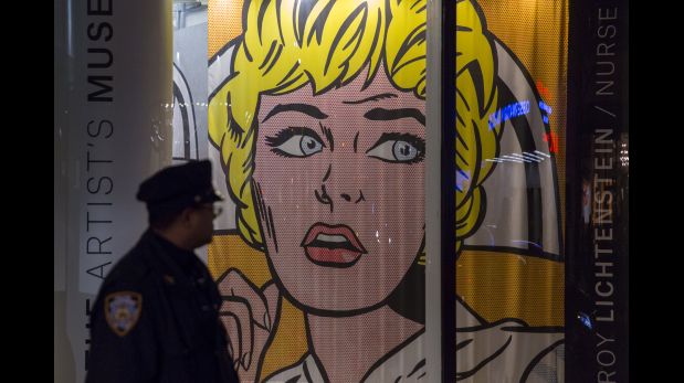 A New York police officer stands beside Christie's window featuring Roy Lichtenstein's 
