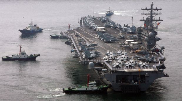 U.S. aircraft carrier USS Ronald Reagan is escorted into the Navy base for making a routine port visit at Busan port in Busan, south of Seoul, South Korea, Monday, July 14, 2008. Carrying more than 5,000 crew, the nuclear-powered ship docked at a port in the southeastern city of Busan. (AP Photo/ Lee Jin-man)