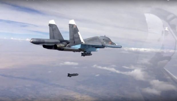 In this photo made from the footage taken from Russian Defense Ministry official web site on Friday, Oct. 9, 2015, a bomb is released from Russian Su-34 strike fighter in Syria. Activists report intense fighting between insurgents and Syrian troops in the country?s center amid new territorial gains for the government, backed by Russian airstrikes. (Russian Defense Ministry Press Service via AP)