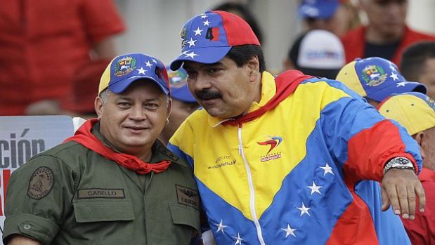 Venezuela's Vice President Nicolas Maduro, right, and Diosdado Cabello, President of Venezuela's National Assembly, attend a demonstration commemorating the anniversary of a failed coup attempt led by Venezuela's President Hugo Chavez in 1992, in Caracas, Venezuela, Monday, Feb. 4, 2013. The president was absent for the first time from the annual demonstrations as crowds gathered for multiple marches wearing the red T-shirts of his socialist movement. Chavez remained in Cuba, where he has been out of sight and hasn't spoken publicly since he underwent cancer surgery on Dec. 11. (AP Photo/Ariana Cubillos)