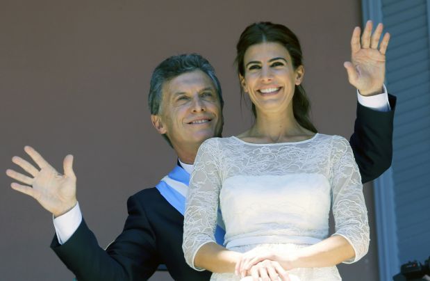 Argentina's President Mauricio Macri dances behind First Lady Juliana Awada from the balcony at the government house in Buenos Aires, Argentina,  Thursday, Dec. 10, 2015. Macri promises to usher in an era of more civil discourse and roll back much of the Fernandez administration spending that many economists say has brought Argentina to the brink of another financial crisis. (AP Photo/Victor R. Caivano)