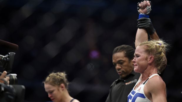 Holly Holm, right, celebrates after defeating Ronda Rousey, left, during their UFC 193 Bantamweight title fight in Melbourne, Australia, Sunday, Nov. 15, 2015. (AP Photo/Andy Brownbill)