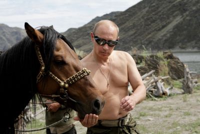 Russian Prime Minister Vladimir Putin is pictured with a horse during his vacation outside the town of Kyzyl in Southern Siberia on August 3, 2009.  AFP PHOTO / RIA-NOVOSTI / ALEXEY DRUZHININ