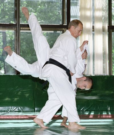 Russian President Vladimir Putin, standing, throws his partner during a judo training session at the presidential residence in Novo-Ogaryovo outside Moscow, in this June 16, 2002 photo. Vladimir Putin is turning 50 on Monday, Oct. 7. (AP Photo/ITAR-TASS, Presidential Press Service)