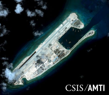 Fiery Cross reef, located in the disputed Spratly Islands in the South China Sea, is shown in this handout Center for Strategic and International Studies (CSIS) Asia Maritime Transparency Initiative satellite image taken September 3, 2015 and released to Reuters October 27, 2015. China's first landing of a plane on one of its new island runways in the South China Sea shows Beijing's facilities in the disputed region are being completed on schedule and military flights will inevitably follow, foreign officials and analysts said. REUTERS/CSIS Asia Maritime Transparency Initiative/DigitalGlobe/Handout via Reuters/Files ATTENTION EDITORS - THIS PICTURE WAS PROVIDED BY A THIRD PARTY. REUTERS IS UNABLE TO INDEPENDENTLY VERIFY THE AUTHENTICITY, CONTENT, LOCATION OR DATE OF THIS IMAGE. THIS PICTURE IS DISTRIBUTED EXACTLY AS RECEIVED BY REUTERS, AS A SERVICE TO CLIENTS. FOR EDITORIAL USE ONLY. NOT FOR SALE FOR MARKETING OR ADVERTISING CAMPAIGNS. NO RESALES. NO ARCHIVE. MANDATORY CREDIT.