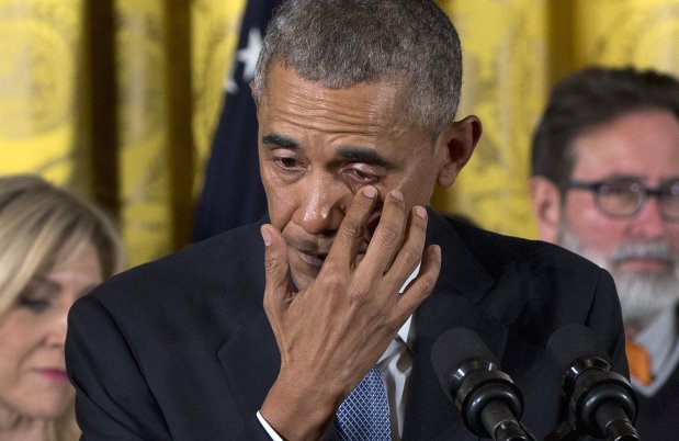 President Barack Obama wipes tears from his eyes as he speaks in the East Room of the White House in Washington, Tuesday, Jan. 5, 2016, about steps his administration is taking to reduce gun violence. Also on stage are stakeholders, and individuals whose lives have been impacted by the gun violence. (AP Photo/Carolyn Kaster)