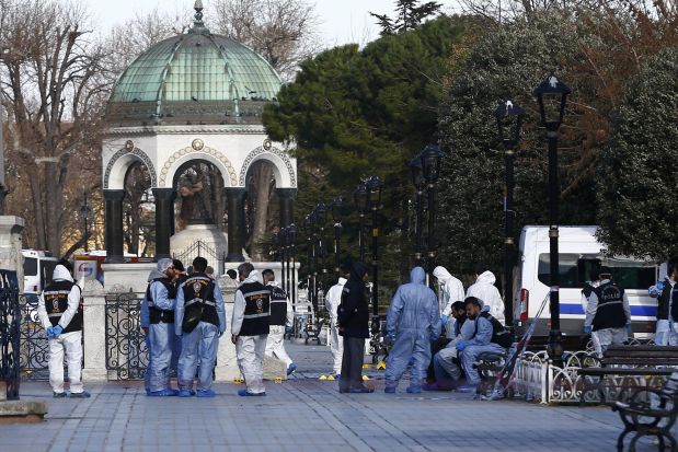 Police forensic officers attend the scene after an explosion in front of the German Fountain in Sultanahmet Square in Istanbul, Turkey January 12, 2016. Ten people were killed and fifteen others were wounded after a large explosion rocked a central Istanbul square on Tuesday, a statement from the Istanbul governor's office said.    REUTERS/Murad Sezer TPX IMAGES OF THE DAY