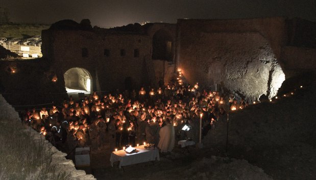 In this April 3, 2010, photo released by the U.S. Army, soldiers celebrate a Catholic Easter mass at St. Elijah's Monastery on the outskirts of Mosul, Iraq. Before it was razed, the partially restored, 27,000-square-foot stone and mortar building stood fortress-like on a hill above Mosul. Although the roof was largely missing, it had 26 distinctive rooms including a sanctuary and chapel. Satellite photos taken after its destruction show ?that the stone walls have been literally pulverized,? said imagery analyst Stephen Wood, CEO of Allsource Analysis, who pinpointed the destruction between August and September 2014. (Staff Sgt. Russell Lee Klika/U.S. Army via AP)