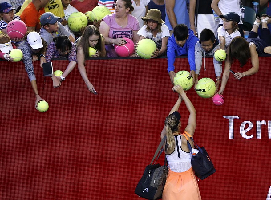 Maria Sharapova of Russia signs autographs following her second round win over Aliaksandra Sasnovich of Belarus at the Australian Open tennis championships in Melbourne, Australia, Wednesday, Jan. 20, 2016.(AP Photo/Vincent Thian)