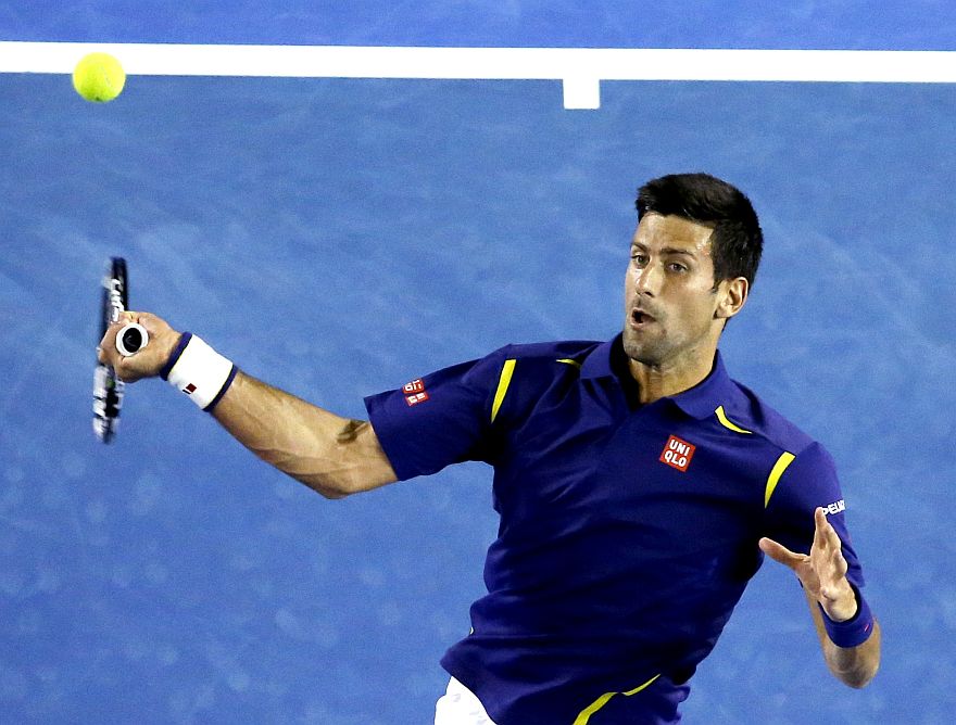 Novak Djokovic of Serbia hits a forehand return to Quentin Halys of France during their second round match at the Australian Open tennis championships in Melbourne, Australia, Wednesday, Jan. 20, 2016.(AP Photo/Vincent Thian)