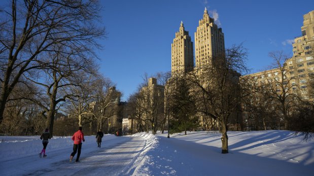 Joggers make their way along a snow covered road in New York's Central Park Sunday, Jan. 24, 2016, in the wake of a storm that dumped heavy snow along the East Coast. (AP Photo/Craig Ruttle)