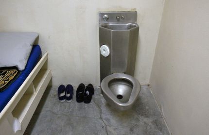 The interior of an unoccupied cell showing standard issue clothing given to prisoners is seen at Camp VI, a prison used to house detainees at the U.S. Naval Base at Guantanamo Bay, March 5, 2013. The facility is operated by the Joint Task Force Guantanamo and holds prisoners who have been captured in the war in Afghanistan and elsewhere since the September 11, 2001 attacks. Picture taken March 5, 2013.  REUTERS/Bob Strong  (CUBA - Tags: POLITICS MILITARY CRIME LAW)
