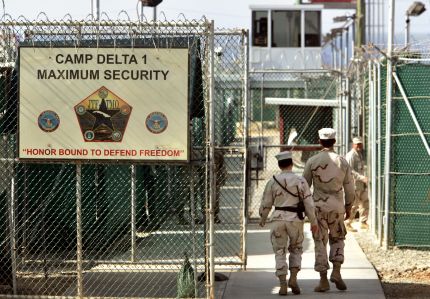 In this photo, reviewed by a US Department of Defense official, U.S. military guards walk within Camp Delta military-run prison, at the Guantanamo Bay U.S. Naval Base, Cuba on Tuesday, June 27, 2006. The Supreme Court ruled Thursday that President George W. Bush overstepped his authority in creating military war crimes trials for Guantanamo Bay detainees, a rebuke to the administration and its aggressive anti-terror policies. (AP Photo/Brennan Linsley)OPSE 2006JUN30 CUBA ESTADOS UNIDOS BASE NAVAL DE GUANTANAMO2006JUN30 AFD