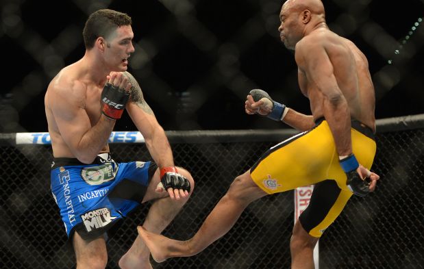 Dec 28, 2013; Las Vegas, NV, USA;   (EDITORS NOTE: graphic content) Anderson Silva (blue gloves) breaks his leg on a kick to Chris Weidman (red gloves) during their UFC middleweight championship bout at the MGM Grand Garden Arena. Mandatory Credit: Jayne Kamin-Oncea-USA TODAY Sports