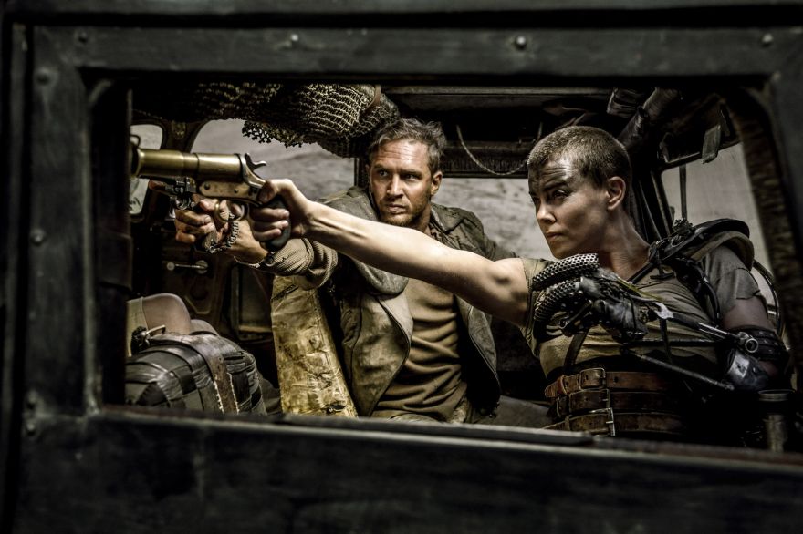 This photo provided by Warner Bros. Pictures shows Tom Hardy, left, and Charlize Theron in a scene from 