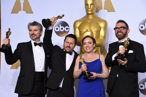 Andrew Whitehurst (R), Paul Norris (2nd L), Mark Ardington (L) and Sara Bennett pose with their Oscar for Best Visual Effects, 