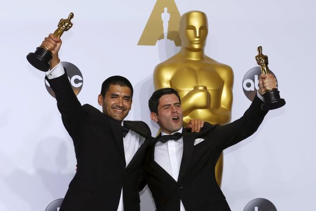Pato Escala (R) and Gabriel Osorio celebrate after winning the Oscar for Best Animated Short Film for 