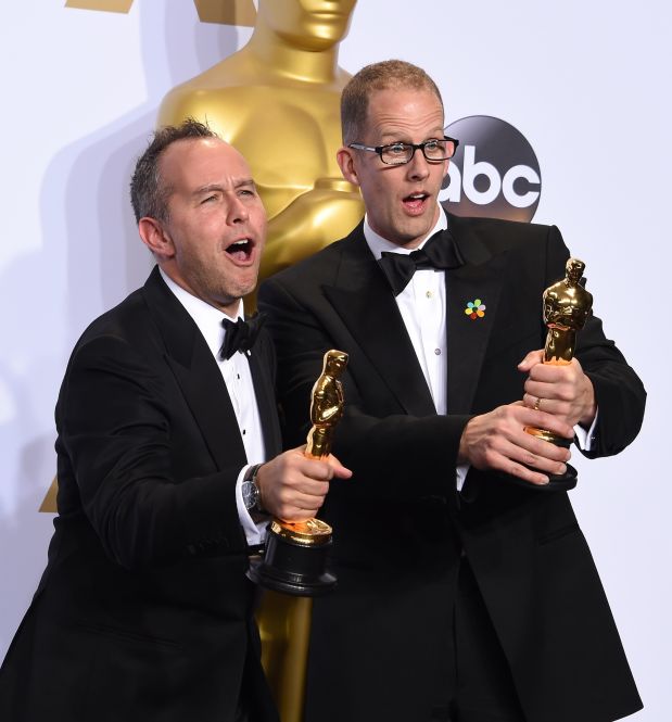 Pete Docter (R) and Jonas Rivera pose with their Oscar for Best Animated Feature Film, 