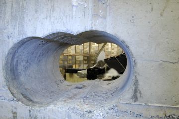 (FILES) A handout photo received from the British Metropolitan Police Service (MPS) in London on April, 22, 2015, shows holes bored through a half-meter thick concrete wall drilled to access a vault in a safe deposit centre in Hatton Garden, London, where an estimated ?14 million worth of jewellery and valuables were stolen between April 2 and April 5, 2015. Three men, Carl Wood, Hugh Doyle and William Lincoln, were found guilty on January 14, 2016 of involvement in the raid. Four other men, Terry Perkins, John Collins, Daniel Jones and Brian Reader, had all previously pleaded guilty to conspiracy to commit burglary. An eighth man Jon Harbinson, was cleared of all charges at the conclusion of the trial.  RESTRICTED TO EDITORIAL USE - MANDATORY CREDIT  