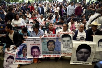 Parents and other relatives of the 43 missing students from the Ayotzinapa's teachers school attend the reading of the final report from the Interdisciplinary Group of Independent Experts (GIEI) in Mexico City on April, 24, 2016. / AFP / YURI CORTEZ