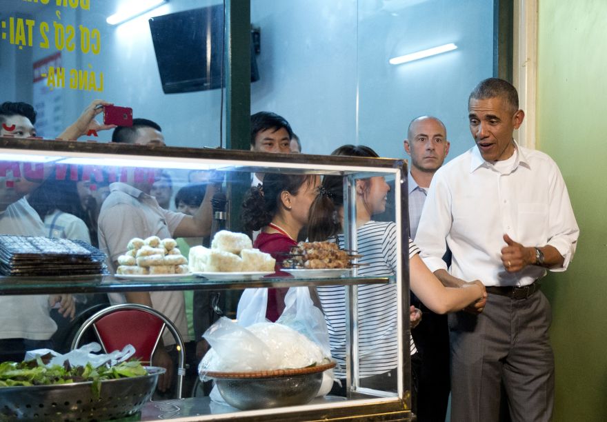 President Barack Obama greets women at the door as he walks from the B?n ch? Huong Li?n restaurant after having dinner with American Chef Anthony Bourdain in Hanoi, Vietnam, Monday, May 23, 2016. (AP Photo/Carolyn Kaster)