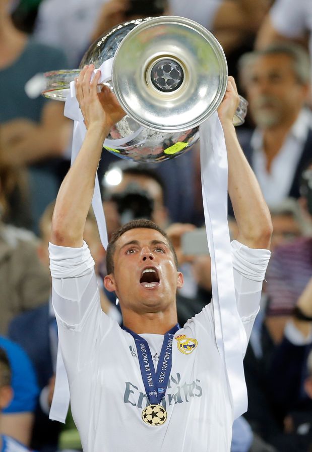 Real Madrid's Cristiano Ronaldo celebrates with the trophy after the Champions League final soccer match between Real Madrid and Atletico Madrid at the San Siro stadium in Milan, Italy, Saturday, May 28, 2016. Real Madrid won 5-4 on penalties after the match ended 1-1 after extra time.    (AP Photo/Manu Fernandez)