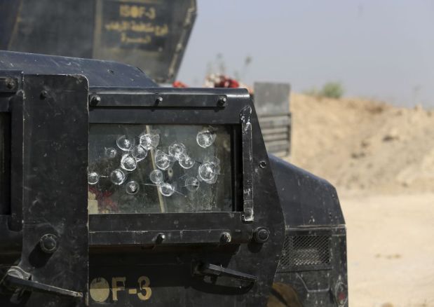 Islamic State militant snipers' bullets mark the windshield of and Iraqi counterterror forces vehicle during fighting in the Nuaimiya neighborhood of Fallujah, Iraq, Wednesday, June 1, 2016. Iraqi forces this week pushed into the city's southern sections after securing surrounding towns and villages more than 50,000 people are believed to be trapped inside the Sunni majority city, about 65 kilometers (40 miles) west of Baghdad.(AP Photo/Khalid Mohammed)