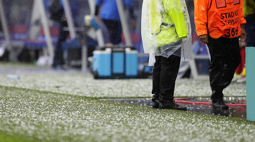 Hail covers the pitch as the game is briefly interrupted due to a hailstorm during the Euro 2016 Group C soccer match between Ukraine and Northern Ireland at the Grand Stade in Decines-?Charpieu, near Lyon, France, Thursday, June 16, 2016. (AP Photo/Pavel Golovkin)