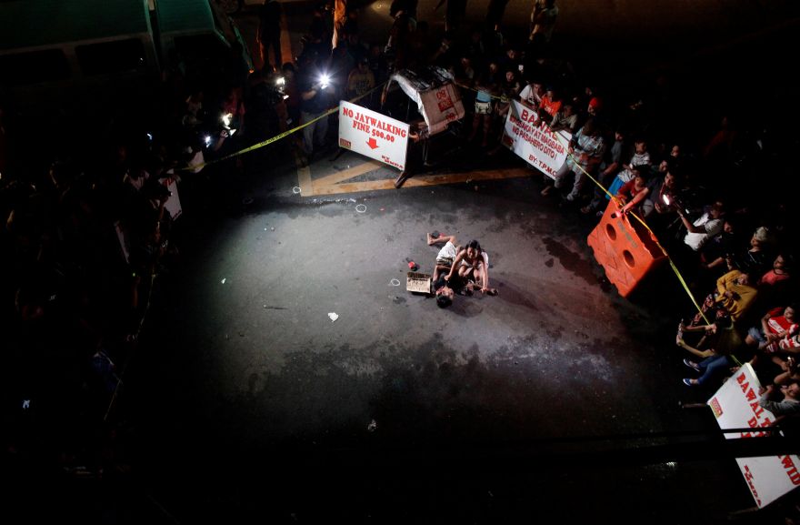 ATTENTION EDITORS - VISUAL COVERAGE OF SCENES OF INJURY OR DEATHA woman weeps over the body of her husband, who was killed on a street by a vigilante group, according to police, in a spate of drug related killings in Pasay city, Metro Manila, Philippines July 23, 2016. A sign on a cardboard found near the body reads: 