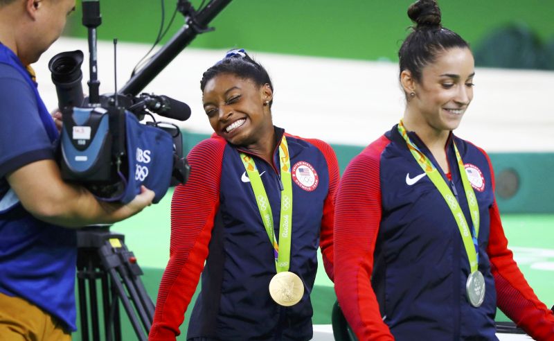 2016 Rio Olympics - Artistic Gymnastics - Victory Ceremony - Women's Individual All-Around Victory Ceremony - Rio Olympic Arena - Rio de Janeiro, Brazil - 11/08/2016. Gold medallist Simone Biles (USA) of USA and silver medallist Alexandra Raisman (USA) of USA (Aly Raisman) (R) walk with their medals during the victory ceremony after the women's individual all-around final. REUTERS/Mike Blake FOR EDITORIAL USE ONLY. NOT FOR SALE FOR MARKETING OR ADVERTISING CAMPAIGNS.